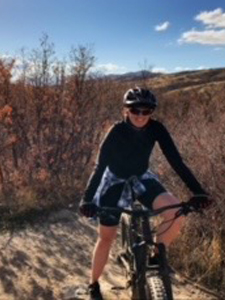 Woman biking in the mountains.