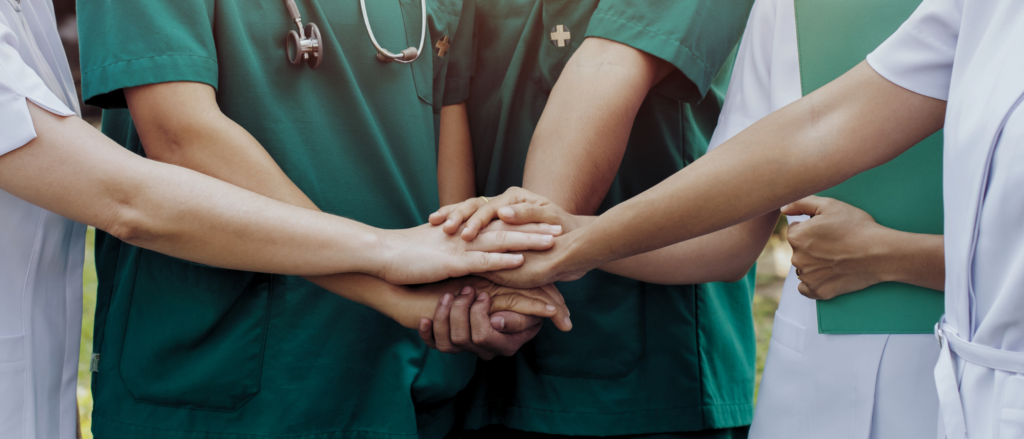health care workers' hands together